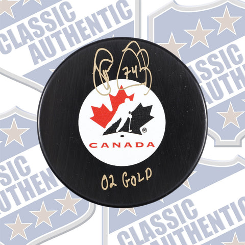 THEO FLEURY Canada Olympic Gold autographed puck w/02 Gold (#8015)